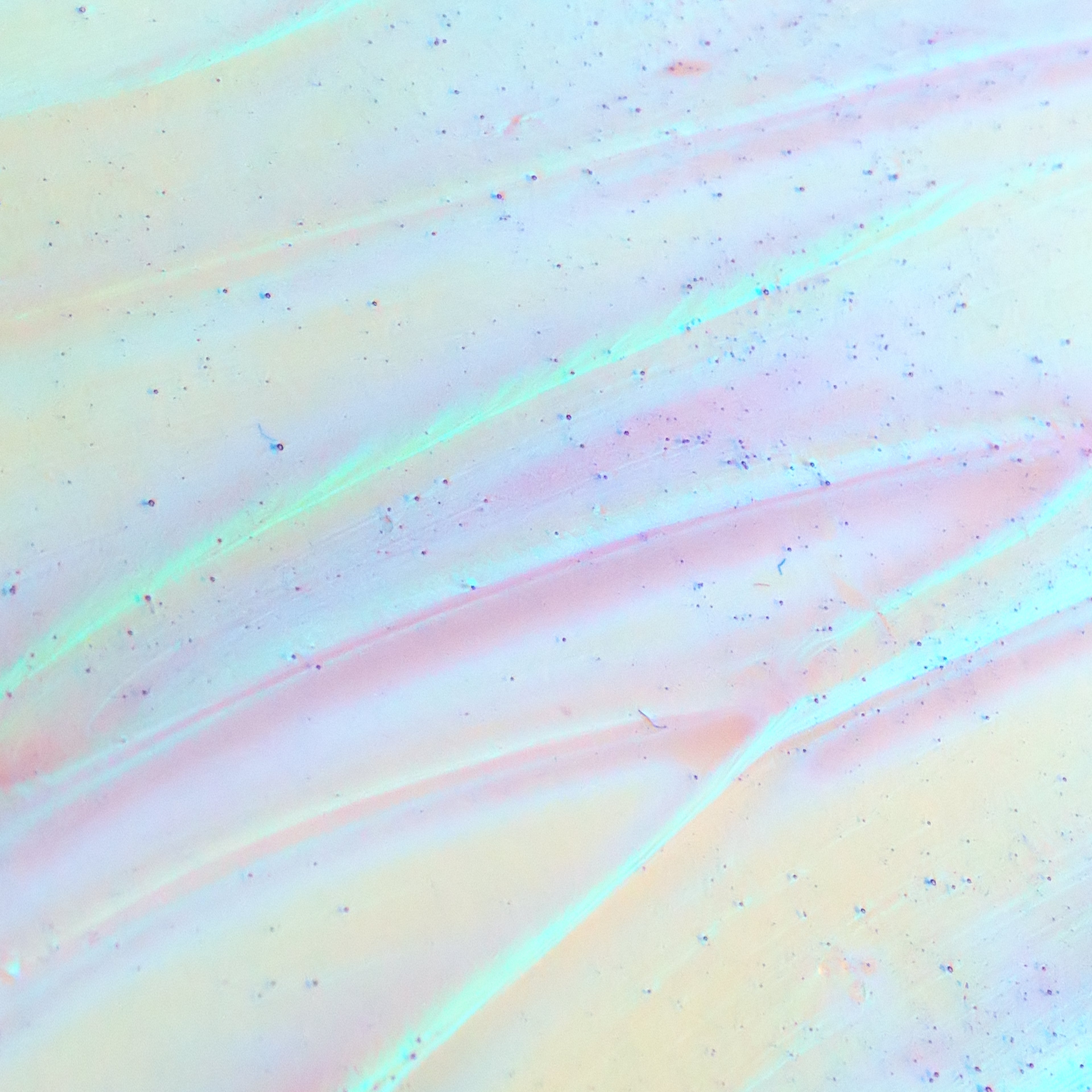 A close up of an iridescent swatch of Cosmedix Opti-Crystal eye serum