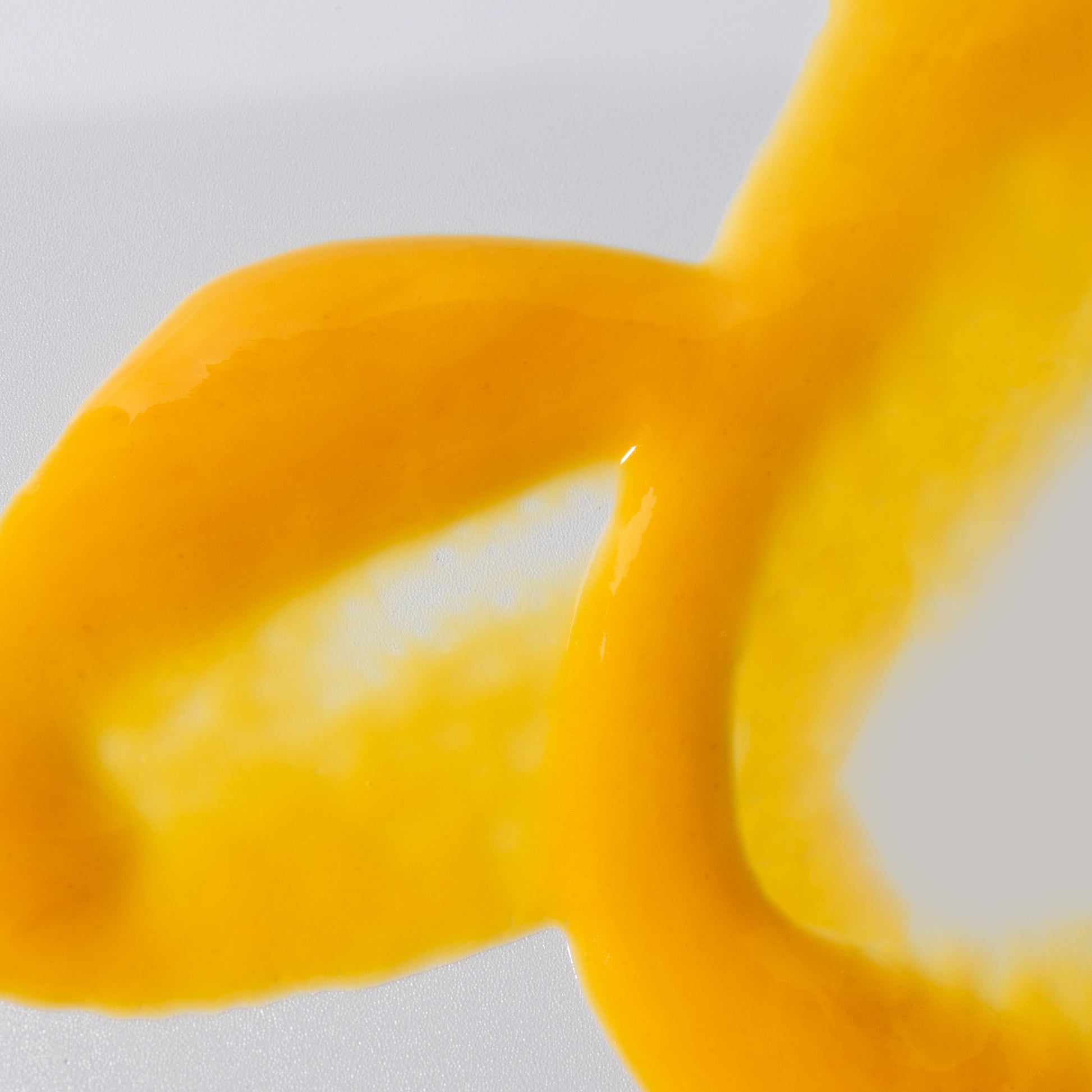 Zoomed in view of COSMEDIX's clarity serum peach colored product swatch