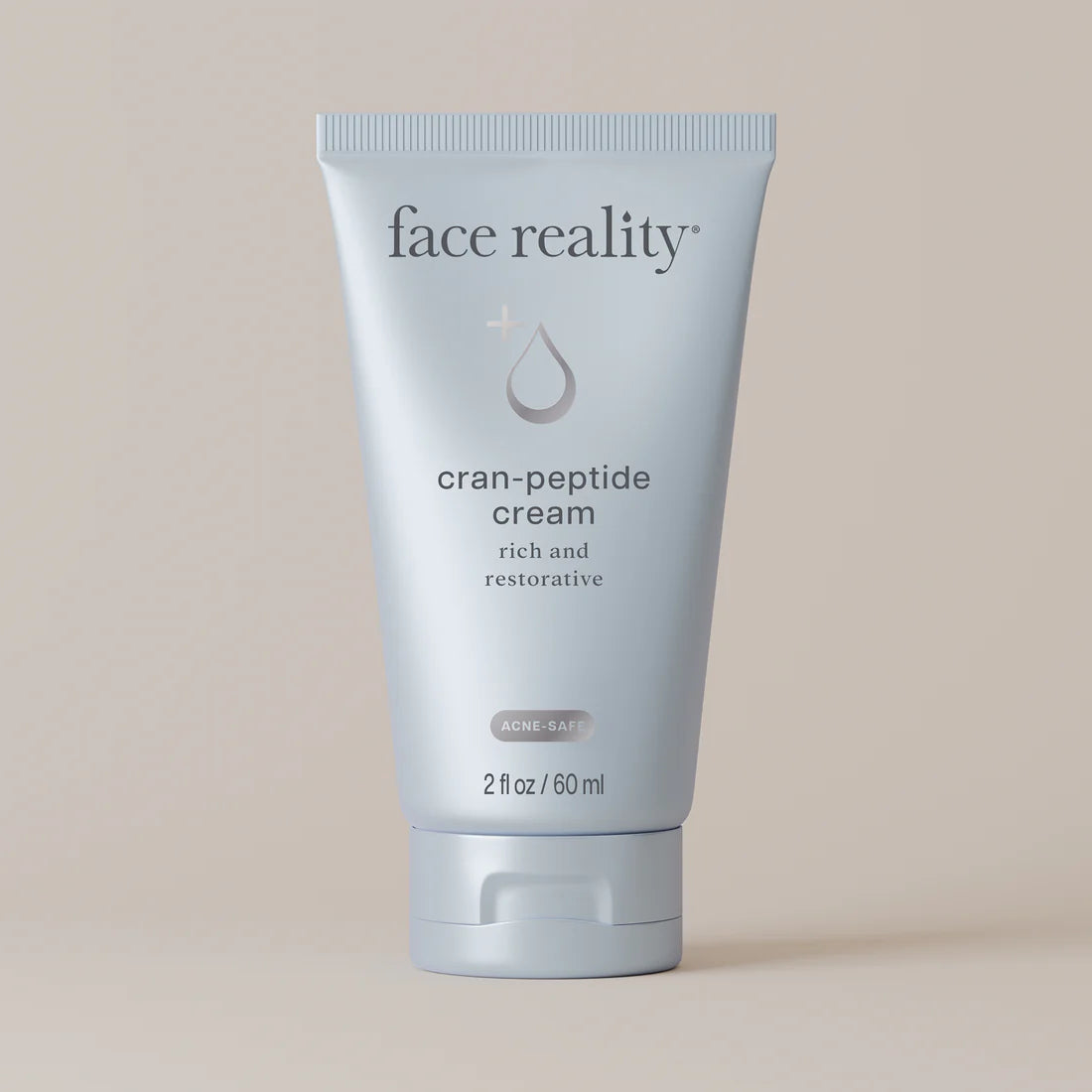 Face Reality's cran-peptide cream light blue product tube with beige background