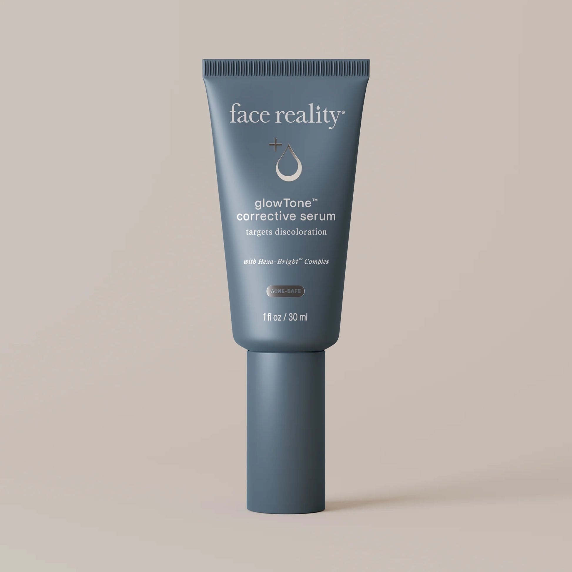 Face Reality's glowTone corrective serum in blue product tube against beige background