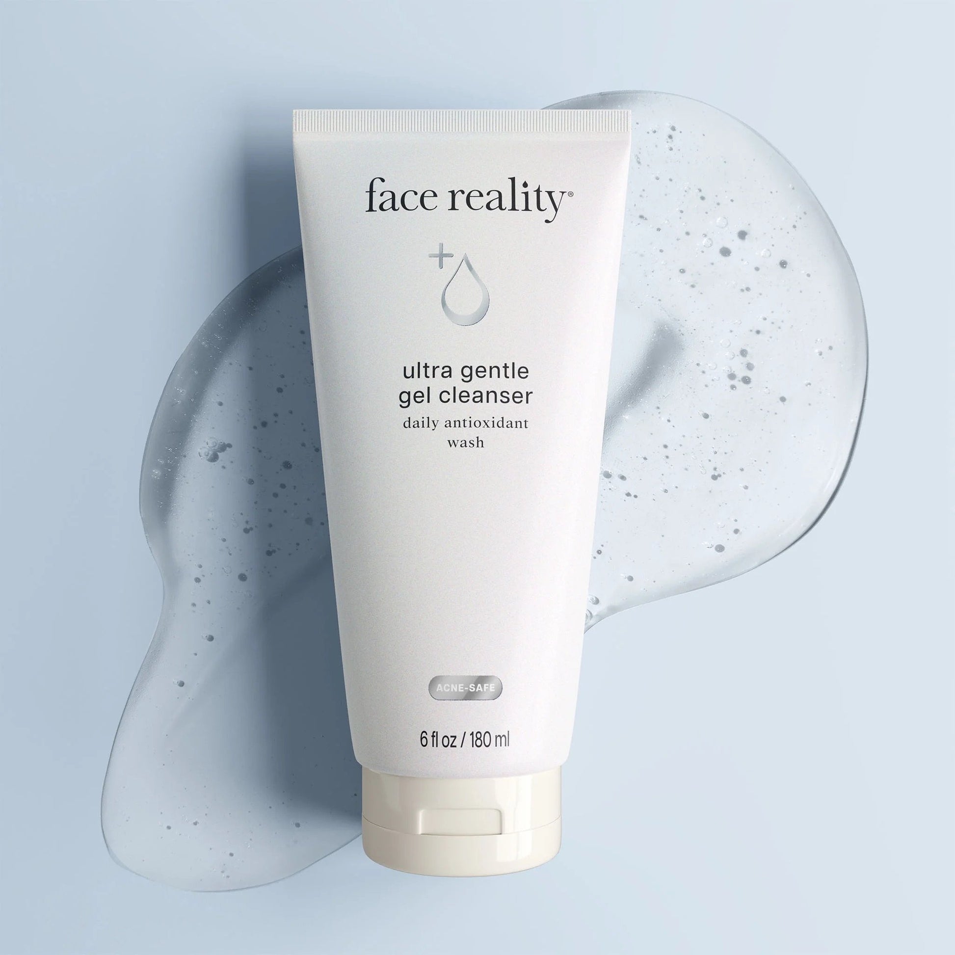 Face Reality's ultra gentle gel cleanser cream-colored product bottle against clear-colored product swatch and light blue background.