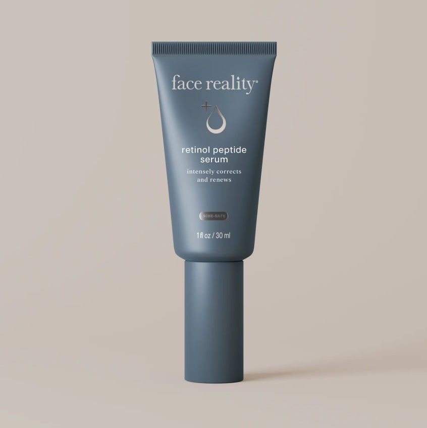 Face Reality's retinol peptide serum blue product tube against beige background
