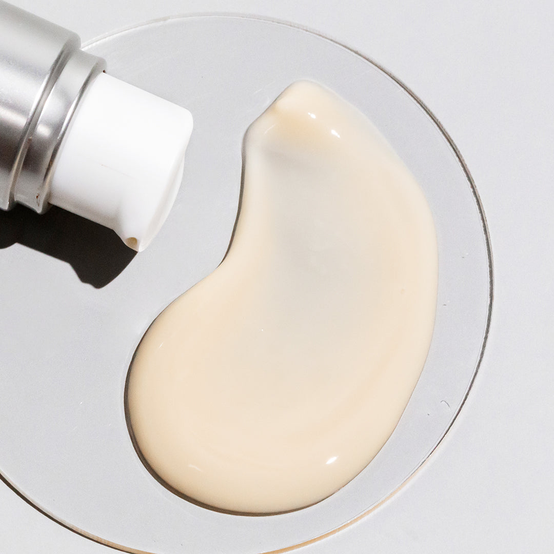COSMEDIX's Serum 16 Rapid Renewal Serum cream colored product swatch on petri dish against grey background