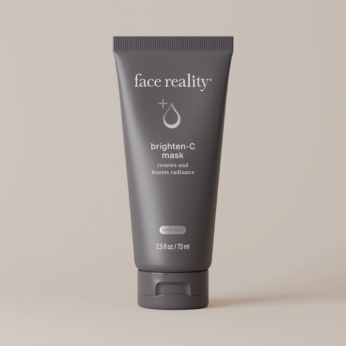 Face Reality's brighten-C mask in dark grey product tube against beige backdop