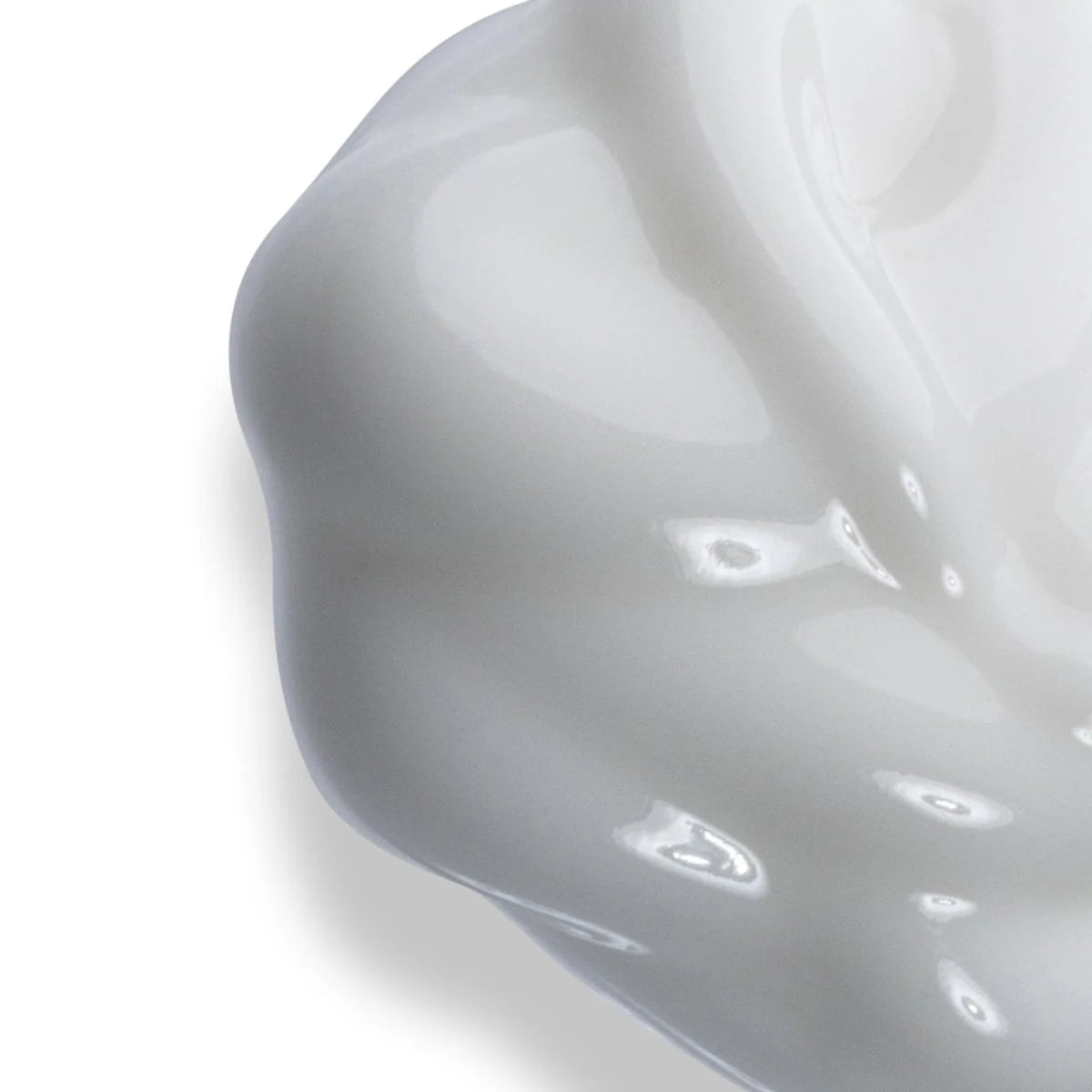 Close-up of a white face cream on a white background