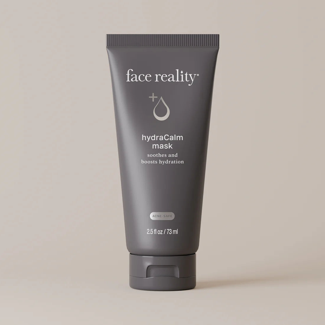 Face Reality's hydraCalm mask pictured in dark grey tube against beige background