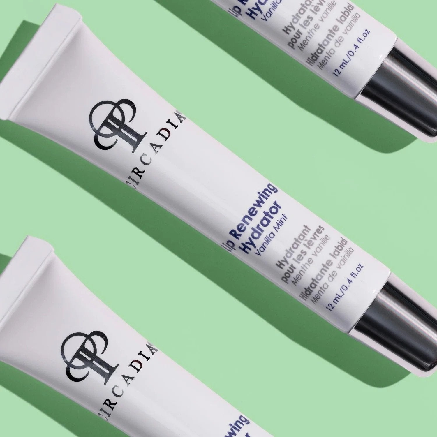 3 white colored tubes of Circadia's Lip Renewing Hydrator against light green background