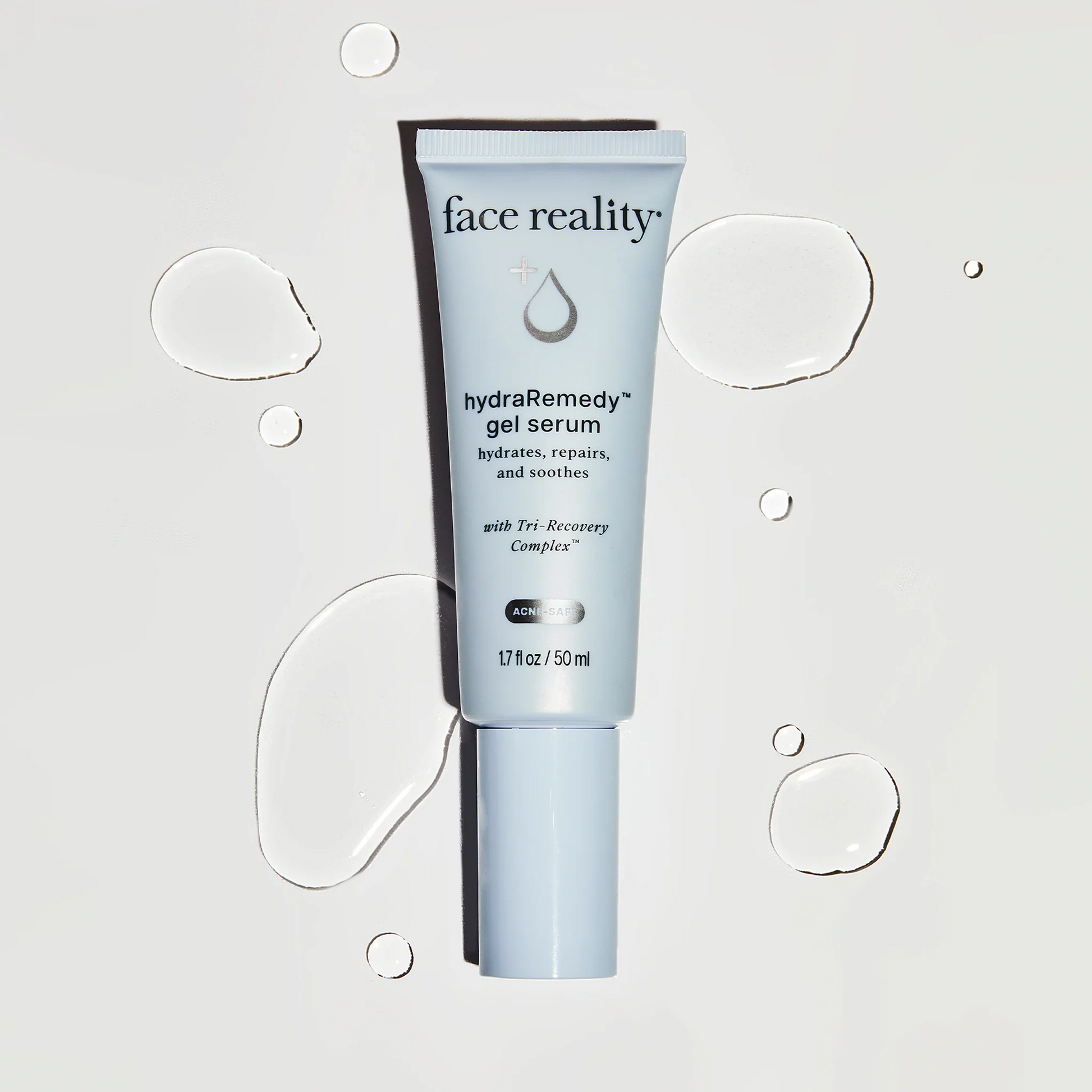 Tube of face reality hydra remedy gel serum on a light gray background with water droplet graphics.