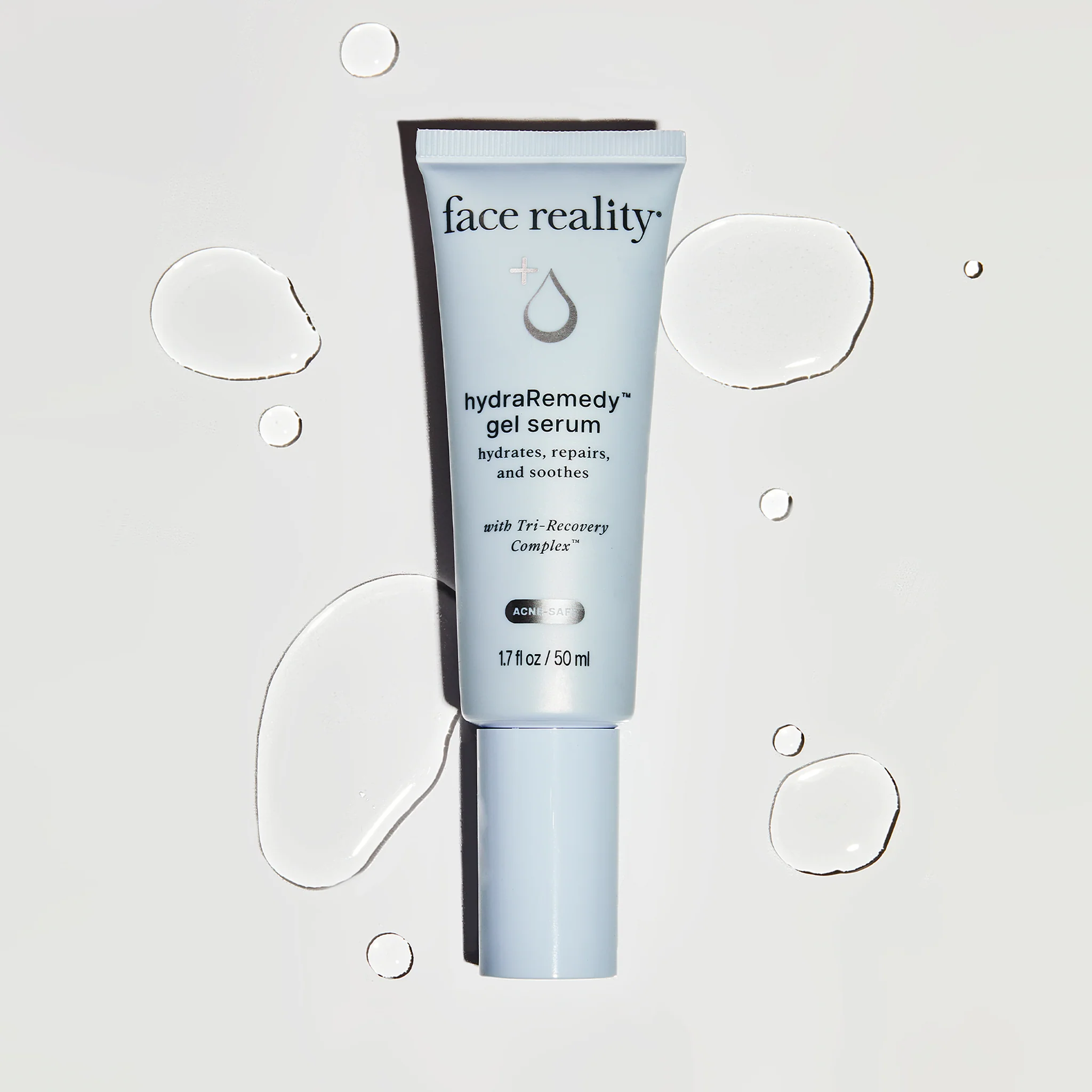 Tube of face reality hydra remedy gel serum on a light gray background with water droplet graphics.