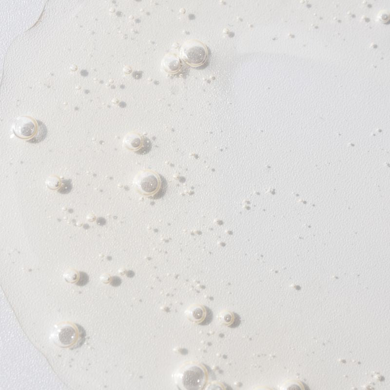 COSMEDIX's C.P.R Skin Recovery Serum zoomed in view of clear-colored product swatch with small bubbles