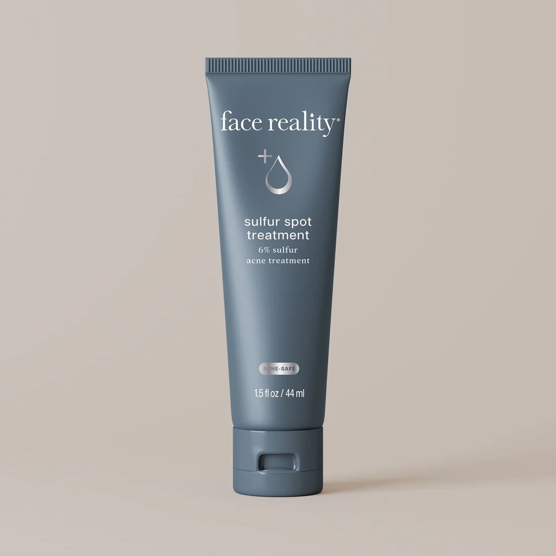 Face Reality's sulfur spot treatment in blue tube against beige background